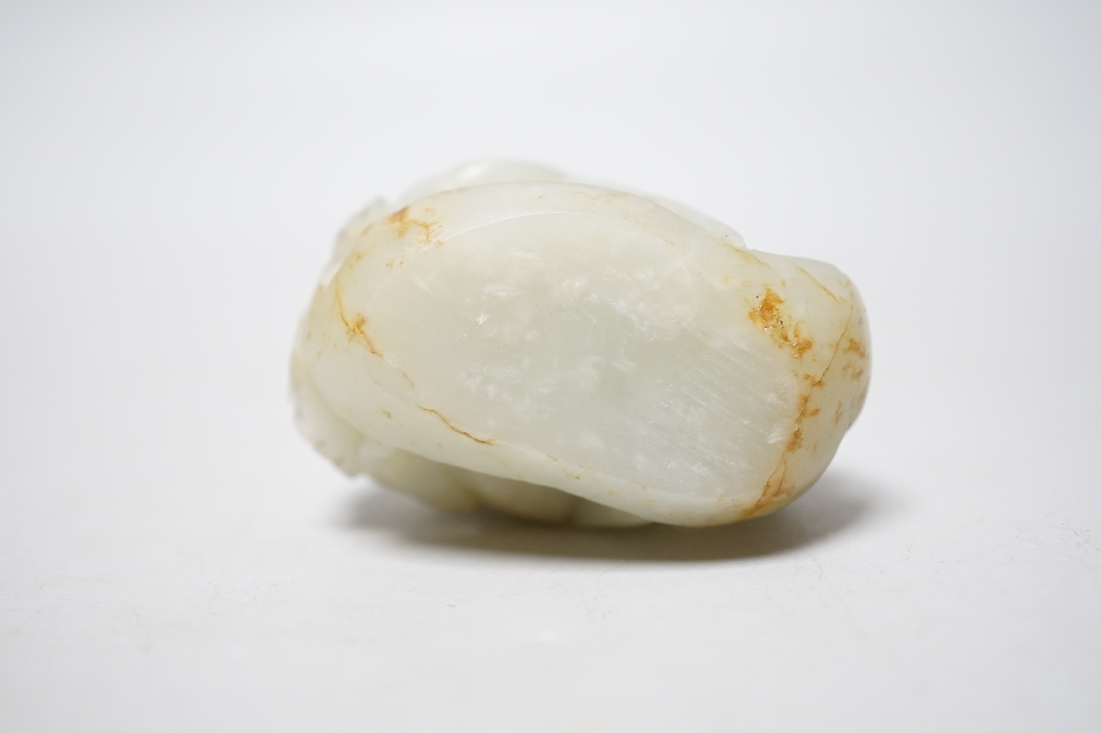 A Chinese pale celadon jade ‘deer’ carving, 7cm